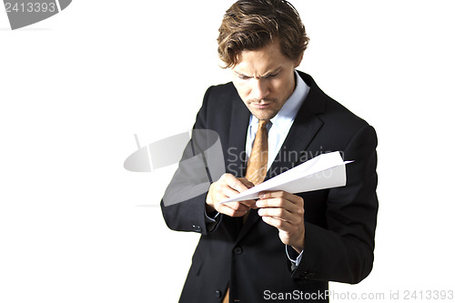 Image of Businessman inspecting paper airplane