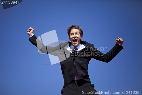 Image of Excited businessman jumping