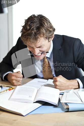 Image of Angry businessman at desk