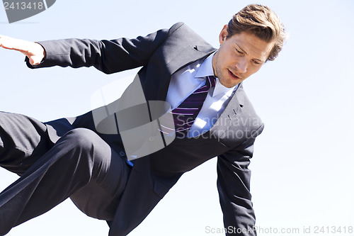 Image of Businessman jumping over something