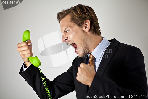 Image of Businessman screaming at phone