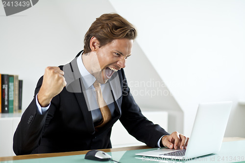 Image of A businessman celebrating a deal