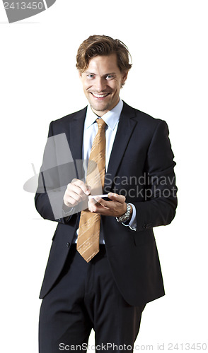 Image of Happy businessman texting on smartphone