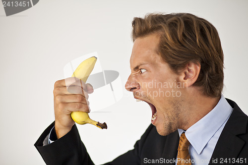 Image of Angry businessman shouting at banana