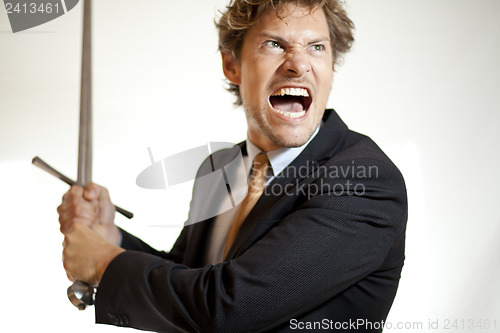 Image of Crazy businessman attacking with a sword