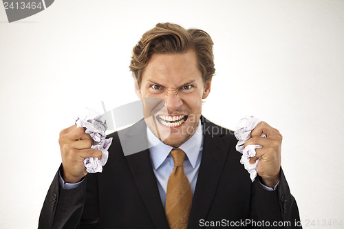 Image of Angry businessman crumbles paper