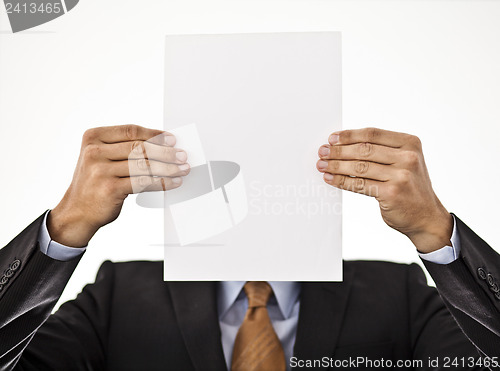 Image of Businessman holding white paper in front of his face