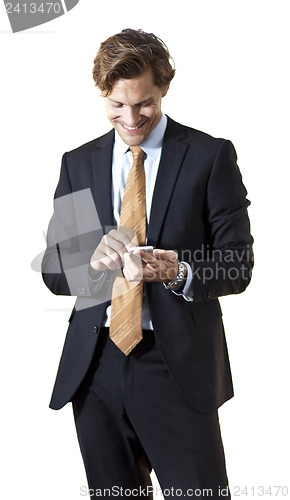 Image of Happy businessman texting