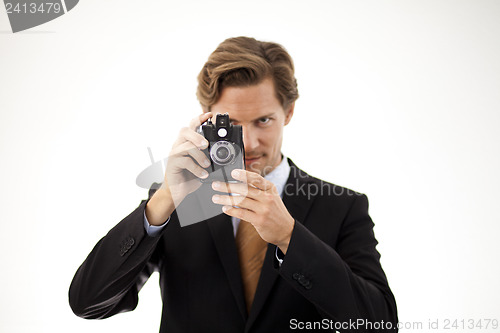 Image of Businessman holding old camera