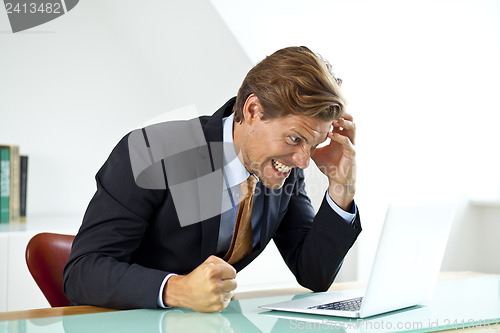 Image of Frustrated Businessman Sitting At Desk In Office Using Laptop