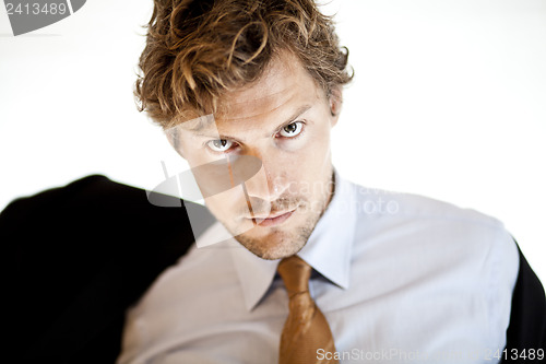 Image of Serious businessman putting on jacket