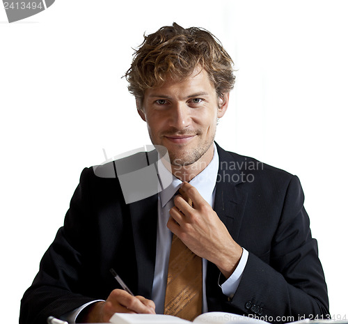 Image of Businessman adjusting his tie smiling