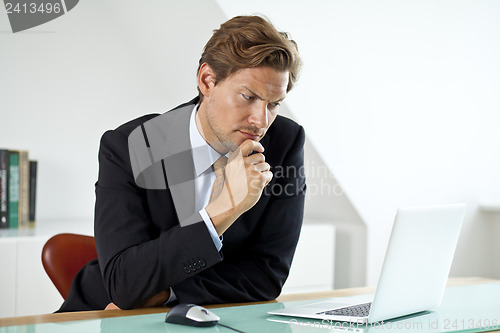 Image of Concerned Businessman in front of laptop