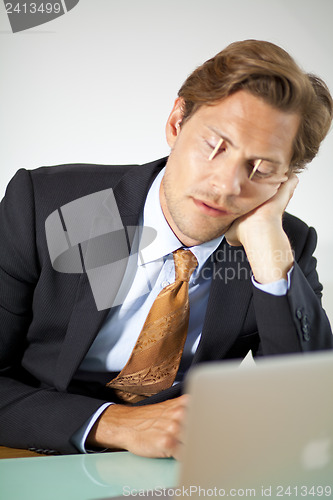 Image of Sleepy businessman trying to stay awake