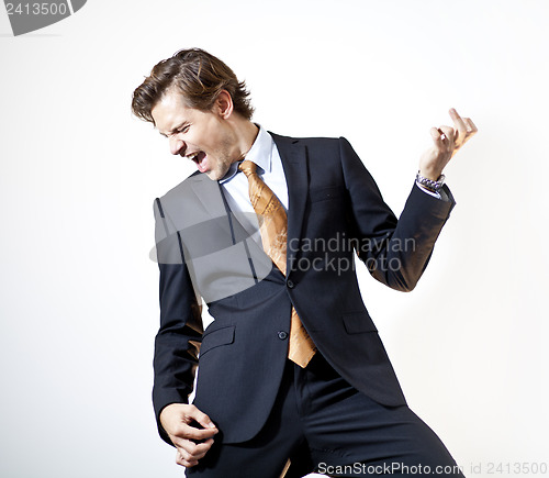 Image of Singing businessman playing air guitar