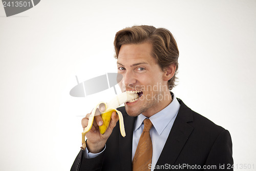 Image of Healthy businessman eating banana