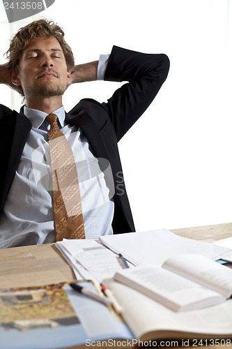 Image of Tired businessman falling asleep at work