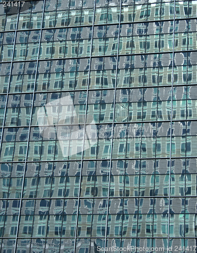 Image of Green reflections in the windows of a skyscraper