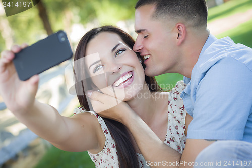Image of Mixed Race Couple Taking Self Portrait in Park