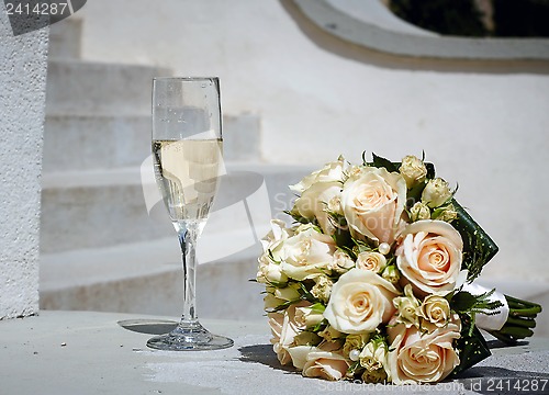 Image of wedding bouquet and glass of champagne