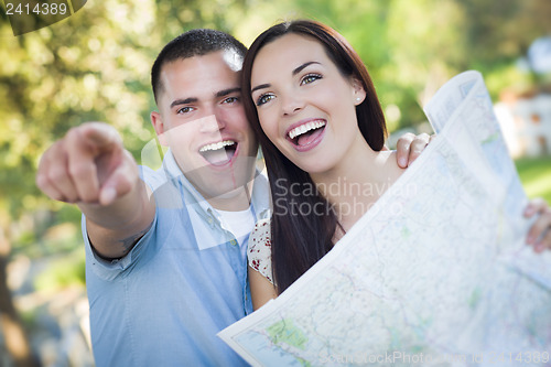 Image of Mixed Race Couple Looking Over Map Outside Together