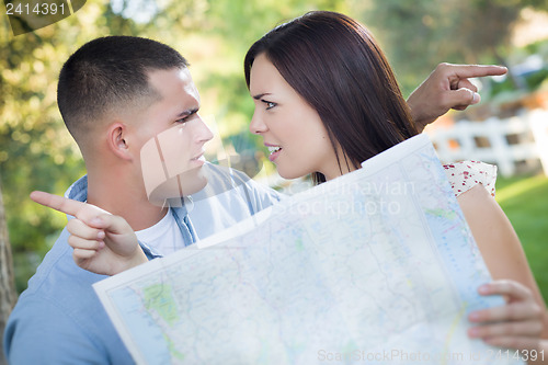Image of Lost and Confused Mixed Race Couple Looking Over Map Outside