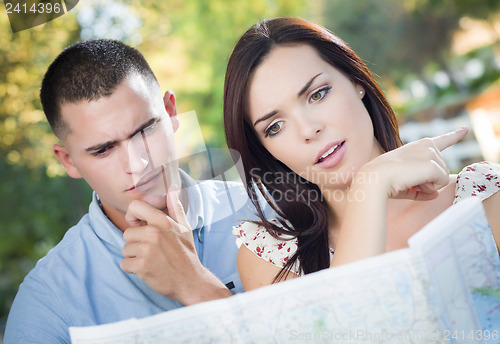 Image of Lost and Confused Mixed Race Couple Looking Over Map Outside