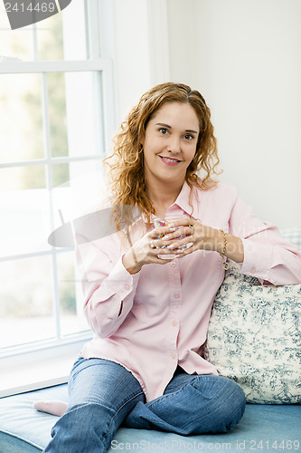 Image of Woman relaxing by the window