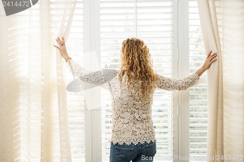 Image of Woman looking out window