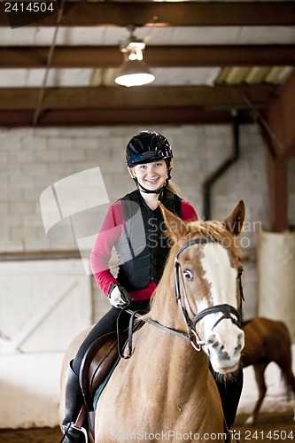 Image of Teen girl riding horse