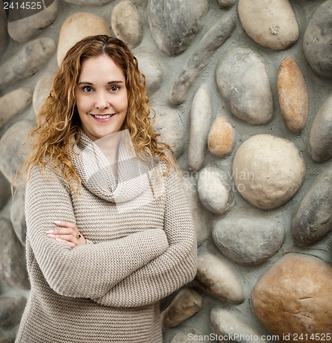 Image of Woman in front of stone wall