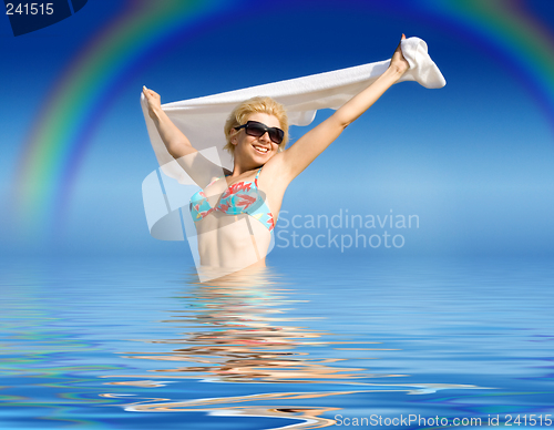 Image of happy girl with towel standing in water