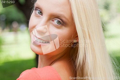 Image of beautiful young blonde girl lying in grass summertime