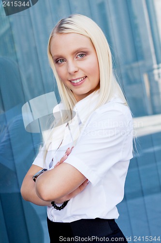 Image of attractive young successful smiling business woman standing outdoor 