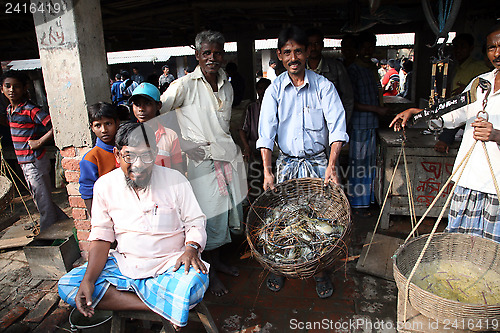 Image of Selling a fish on fish market in Kumrokhali, West Bengal, India