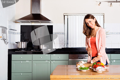 Image of Woman Cutting Vegetables At Kitchen Counter