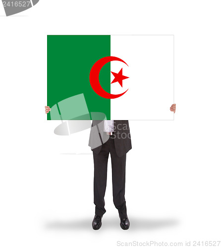 Image of Businessman holding a big card, flag of Algeria