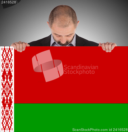 Image of Businessman holding a big card, flag of Belarus