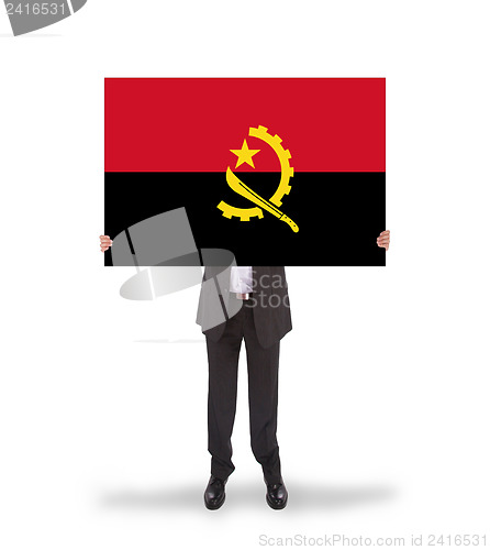 Image of Businessman holding a big card, flag of Angola