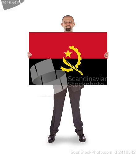 Image of Businessman holding a big card, flag of Angola