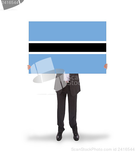 Image of Businessman holding a big card, flag of Botswana