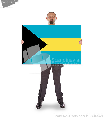 Image of Businessman holding a big card, flag of the Bahamas