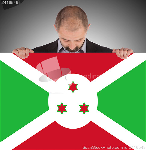 Image of Businessman holding a big card, flag of Burundi