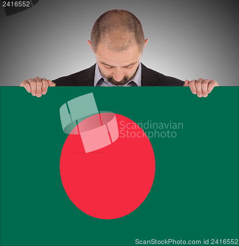 Image of Businessman holding a big card, flag of Bangladesh