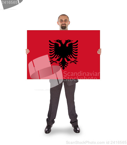 Image of Businessman holding a big card, flag of Albania