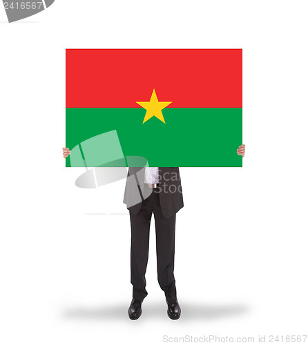 Image of Businessman holding a big card, flag of Burkina Faso