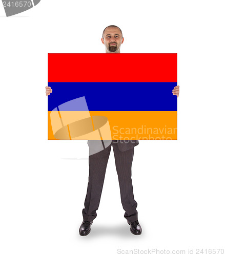 Image of Businessman holding a big card, flag of Armenia