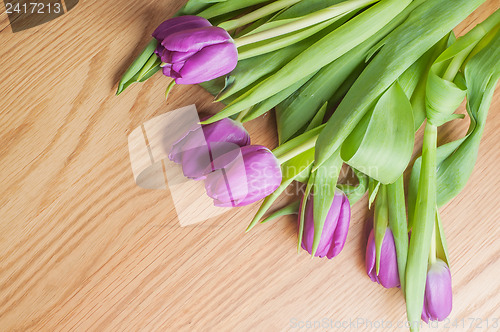 Image of Violet tulips on the wood