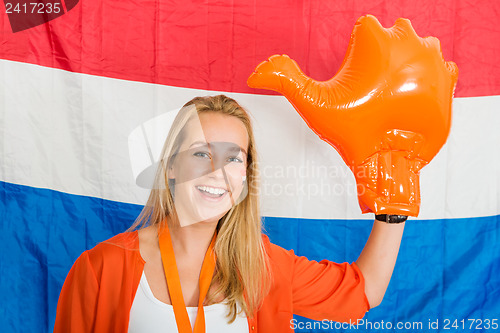 Image of Sports fan Wearing an Inflatable orange Hand Cheering in front o