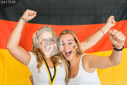 Image of Successful Sportswomen Shouting Against German Flag